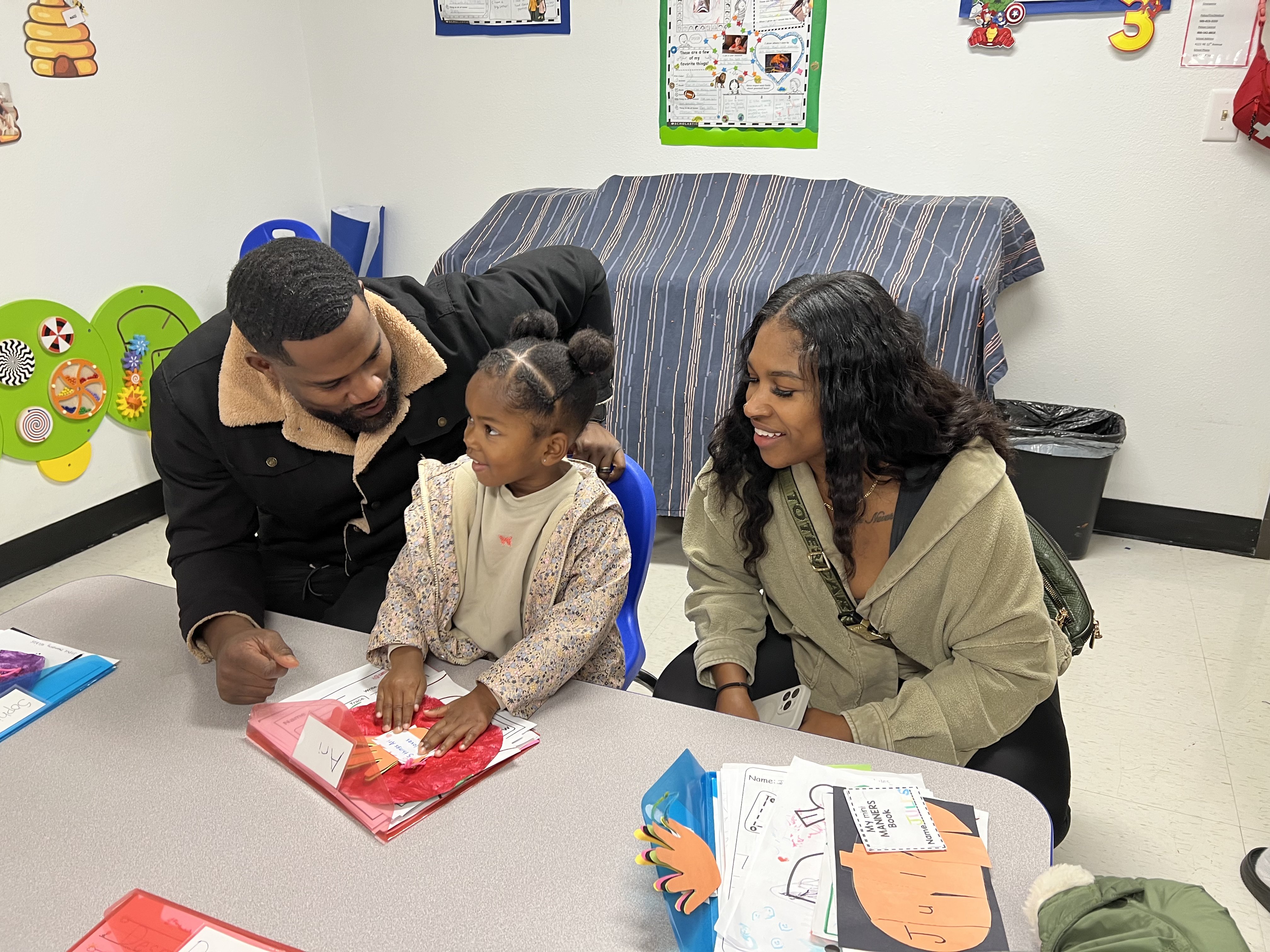 Family celebrating student work at open house